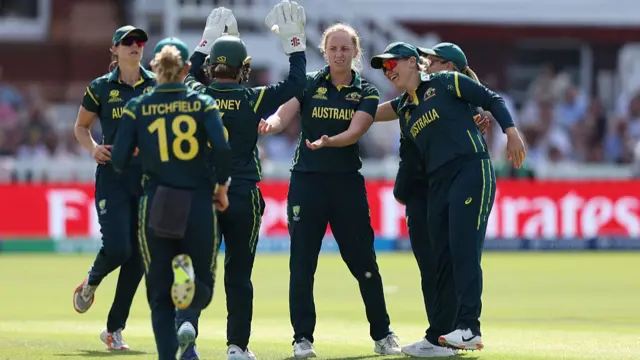 Kim Garth of Australia celebrates after taking the wicket of Heather Knight