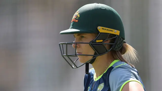 Sophie Molineux, wearing a green Australia helmet, stares