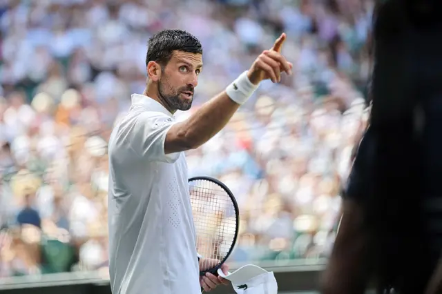 Djokovic points at someone