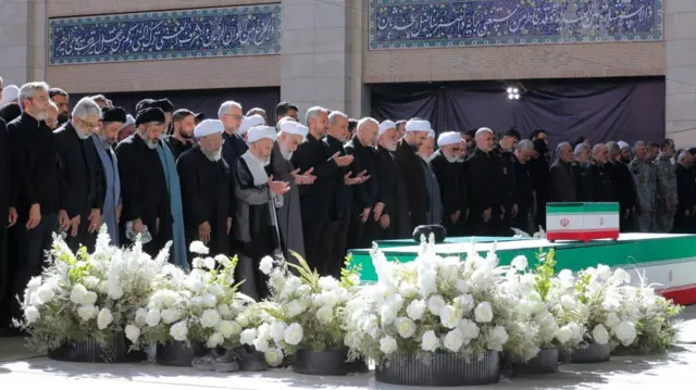 Iranian President Masoud Pezeshkian and Iran's Parliament speaker Mohammad Baqer Qalibaf with officials attend a prayer during a public farewell ceremony to pay their respects to late Supreme Leader Ayatollah Ali Khamenei