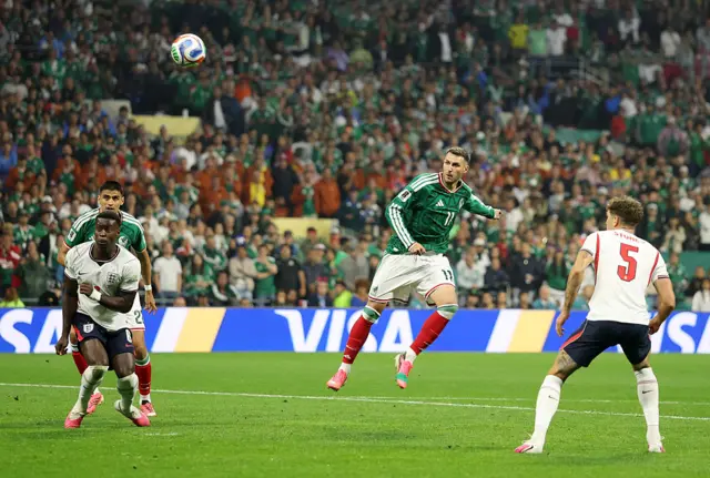 A Mexico player kicks the ball