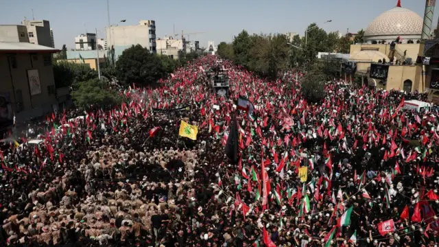 People gather during a funeral procession for Iran's late Supreme Leader Ayatollah Ali Khamenei