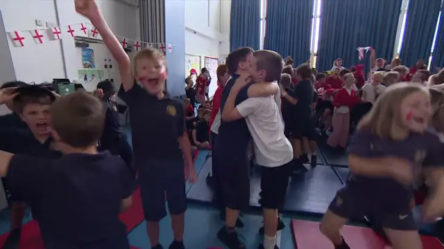 Primary school students celebrating as England win match against Mexico