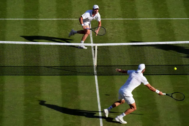 Arthur Fery and Grigor Dimitrov play a point at the net