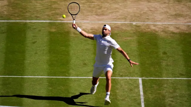 Grigor Dimitrov hits an overhead smash