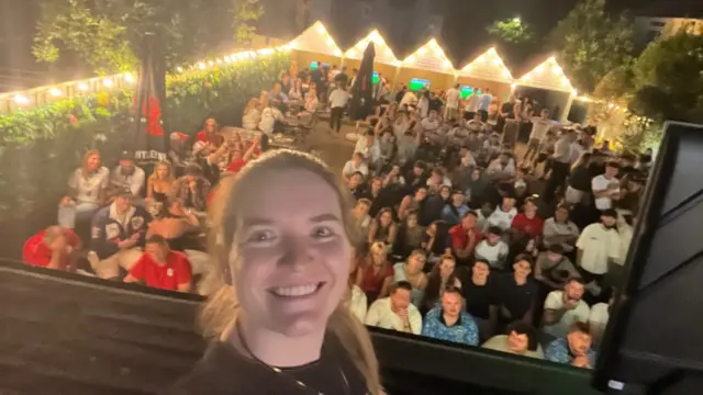Thea Barratt poses with a garden full of England fans