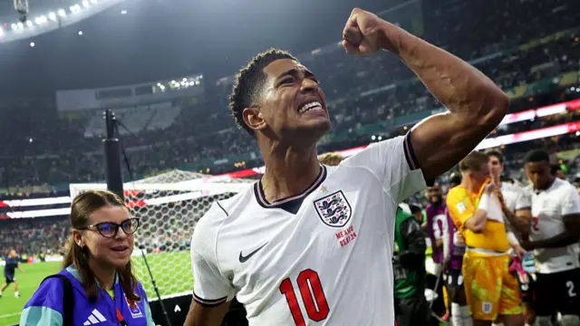 Jude Bellingham pumps his fist in the air as he celebrates England's victory over Mexico