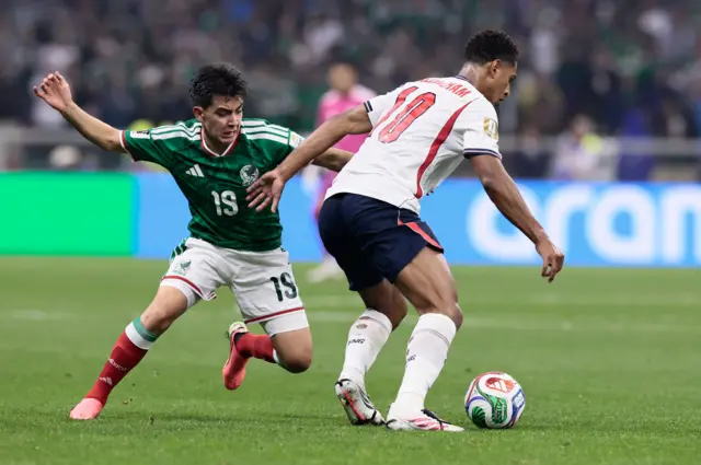 Two players tussle for the ball
