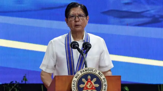 Marcos, in a white shirt, speaks at the anniversary of the Philippine Air Force on 1 July