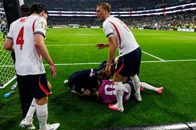 Declan Rice (L) and Dan Burn of England (R) try to help their teammate