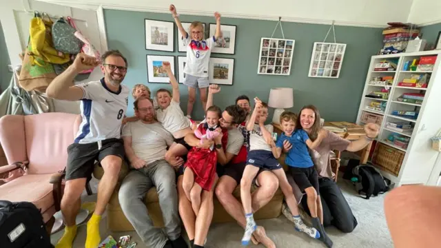 People sat on a sofa celebrating England's win