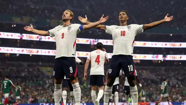 Jude Bellingham #10 of England celebrates with teammate Harry Kane #9 after scoring his team's first goal during the FIFA World Cup 2026 Round of 16 match between Mexico and England at Mexico City Stadium on July 05, 2026 in Mexico City, Mexico.