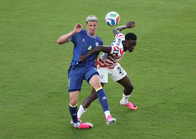 Folarin Balogun #20 of the United States fouls Tarik Muharemovic