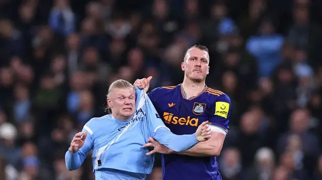Dan Burn of Newcastle United tussles with Erling Haaland of Manchester City during the Premier League match between Manchester City and Newcastle United at Etihad Stadium on February 21, 2026 in Manchester, United Kingdom.