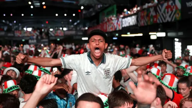 Fans celebrate following a screening of the FIFA World Cup match between England and Mexico at BOXPark Wembley in London