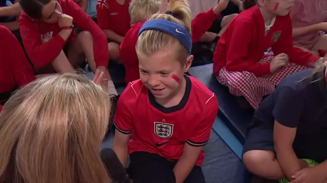 Child taking to BBC reporter