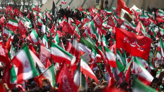 People gather during a funeral procession for Iran's late Supreme Leader Ayatollah Ali Khamenei