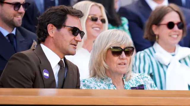 Roger Federer sits next to Debbie Jevans