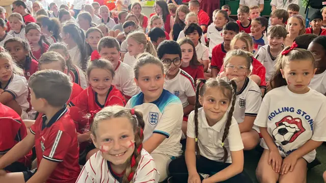 Schoolchildren watch England game