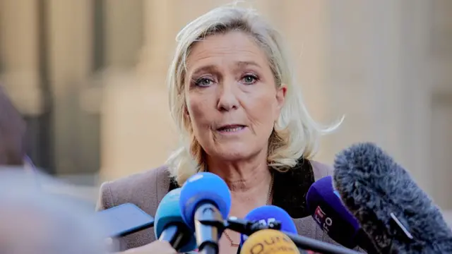 Marine Le Pen, President of the Rassemblement National (RN) parliamentary group, speaks to the press after a meeting with the Prime Minister at Hotel de Matignon in Paris