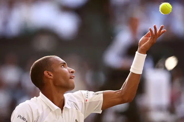 Felix Auger-Aliassime serves