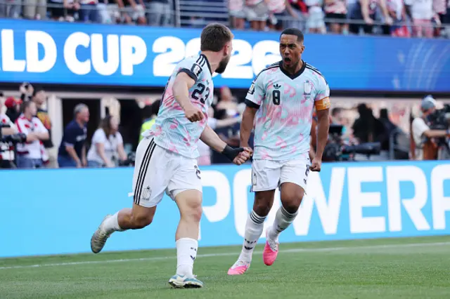 Nicolas Raskin #23 and Youri Tielemans #8 of Belgium celebrate