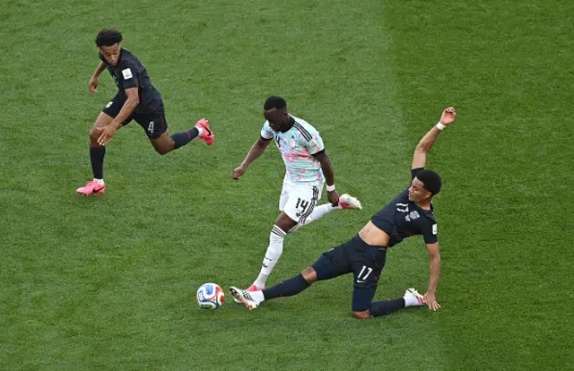 Dodi Lukebakio #14 of Belgium is tackled by Malik Tillman