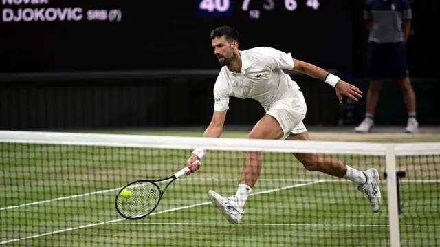 Novak Djokovic of Serbia plays a forehand volley