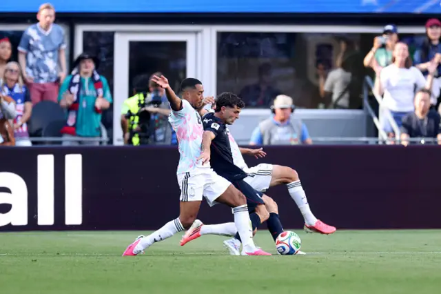 Christian Pulisic #10 of the United States is challenged by Youri Tielemans