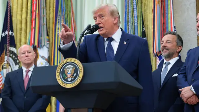 U.S. President Donald Trump talks to reporters in the Oval Office while marking the first day of trading for "Trump Accounts" at the White House on July 06, 2026 in Washington, DC. The accounts are a $1,000 government seed deposit for children born between 2025 and 2028, with family and employer contributions capped at $5,000 annually and restricted to low-cost U.S. equity index funds