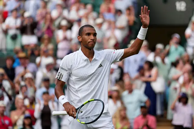 Felix Auger-Aliassime waves to the crowd