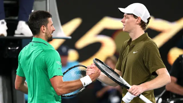 Novak Djokovic shakes hands with Jannik Sinner
