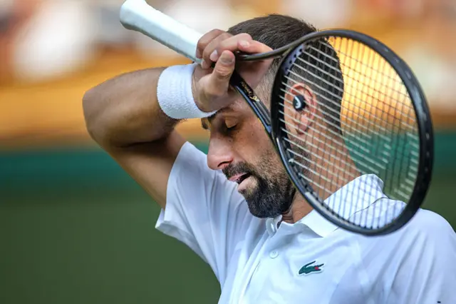 Novak Djokovic of Serbia wipes his forehead