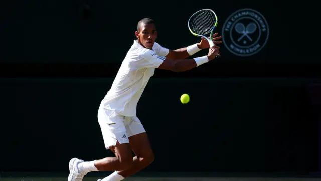 Felix Auger-Aliassime slices a backhand