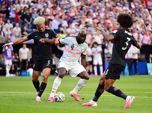 US' Antonee Robinson, Belgium's Romelu Lukaku and US' Chris Richards fight for the ball