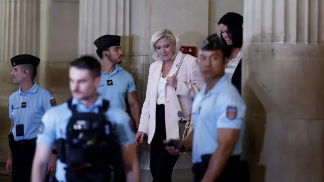 French far-right leader Marine Le Pen, member of parliament for the Rassemblement National (National Rally - RN) party, leaves after the verdict in her appeal trial