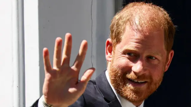 Prince Harry pictured on Tuesday, he is waving to the camera
