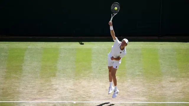 Jannik Sinner serves