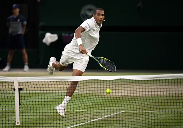 Felix Auger-Aliassime of Canada hits into the net