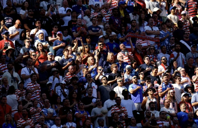 U.S. fans sing their national anthem