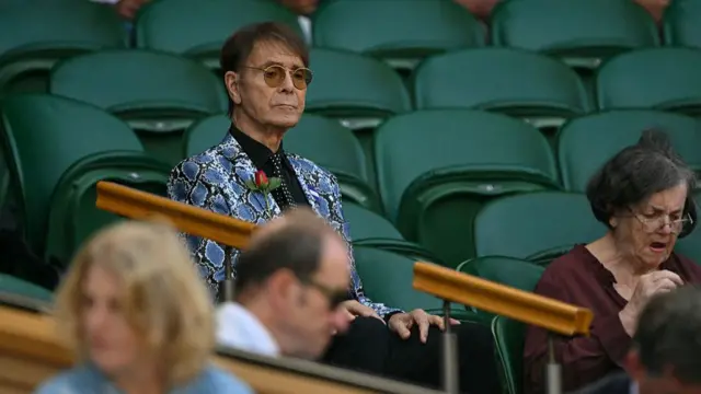 British singer Cliff Richard sits in the royal box