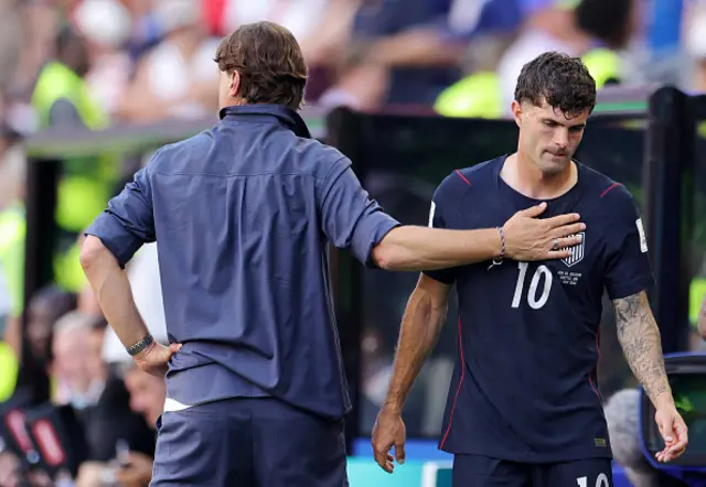 Christian Pulisic #10 of the United States is consoled by Mauricio Pochettino