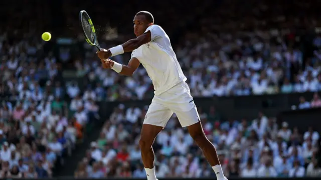 Felix Auger-Aliassime of Canada plays a backhand