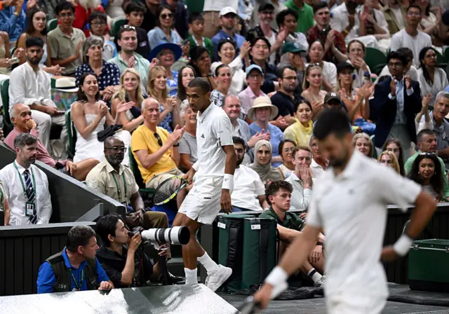 Felix Auger-Aliassime of Canada looks on as he ends up in the crowd