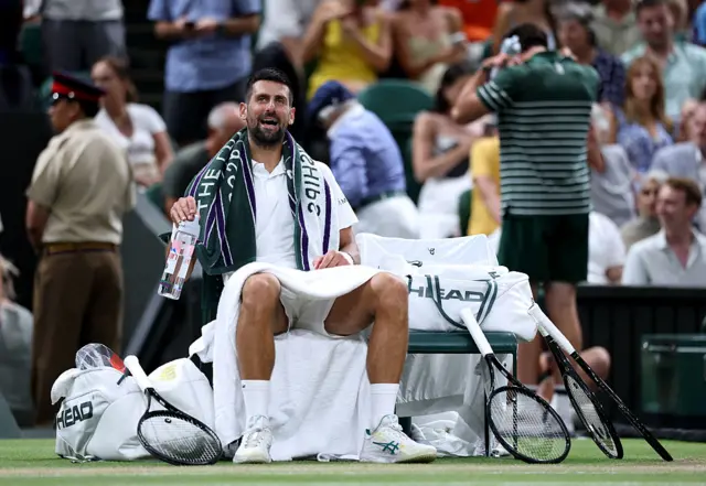 Novak Djokovic of Serbia sits on his bench