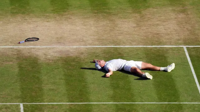 Arthur Fery lies on Centre Court after his victory