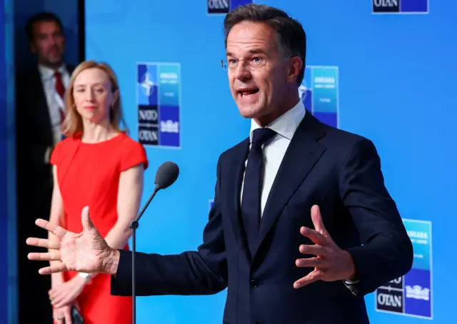 NATO Secretary-General Mark Rutte's hands are stretched out wide as he speaks to the media at the summit in Ankara, Turkey