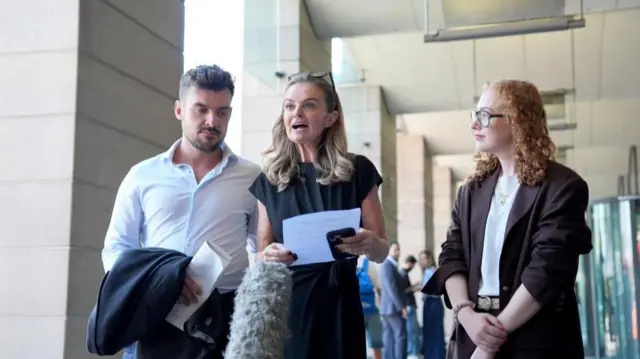 aura Enston (centre), the granddaughter of Ruth Ellis speaks while lawyer Katy Colton stands to her left and a man to her right