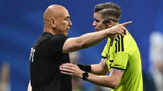 Egypt's head coach Hossam Hassan speaks with French referee Francois Letexier during the 2026 World Cup round of 16 football match between Argentina and Egypt at Atlanta Stadium in Atlanta on July 7, 2026. (