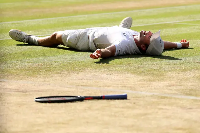 Fery lies on the grass after victory